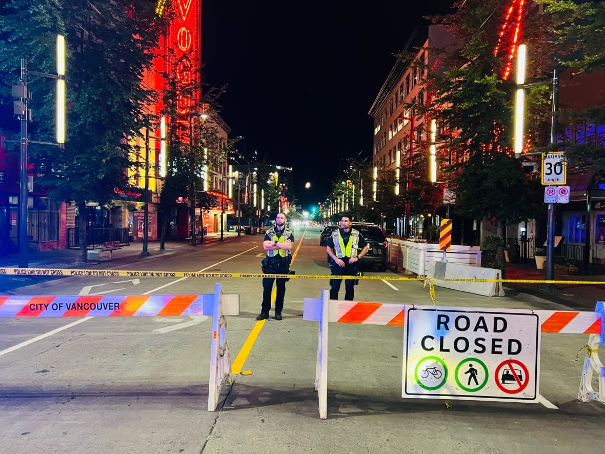 Vancouver police blocked off the busy downtown Granville street Saturday night, after a man allegedly set his suite in a rooming house on fire and attacked four people with a machete. (Luis de la Selva/CBC - image credit)