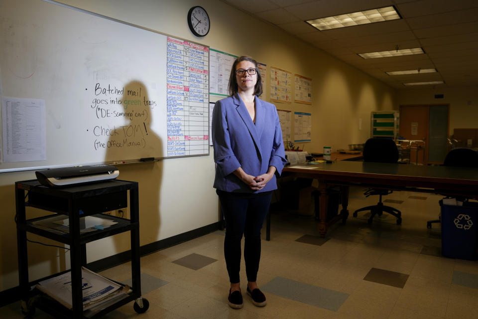 Halei Watkins, communications manager for King County Elections, poses for a portrait in the mail room at elections headquarters, Friday, Nov. 17, 2023, in Renton, Wash. The office began stocking Narcan, the nasal spray version of overdose-reversal drug naloxone, after receiving a letter laced with fentanyl in the summer and was evacuated the day after Election Day after receiving a similar envelope. (AP Photo/Lindsey Wasson)