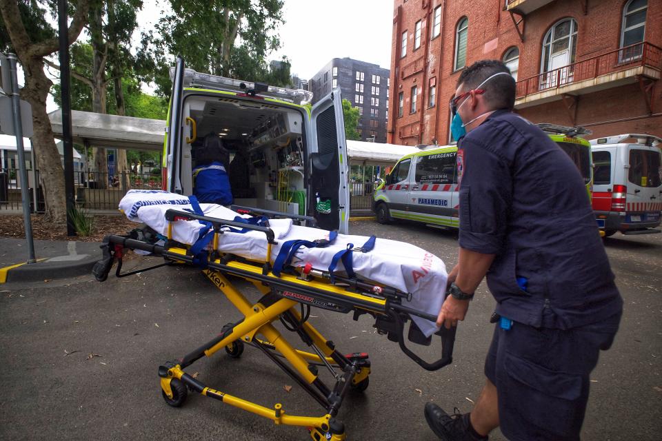 File image shows a paramedic moving equipment outside St. Vincent's Hospital in Melbourne. Source: AAP