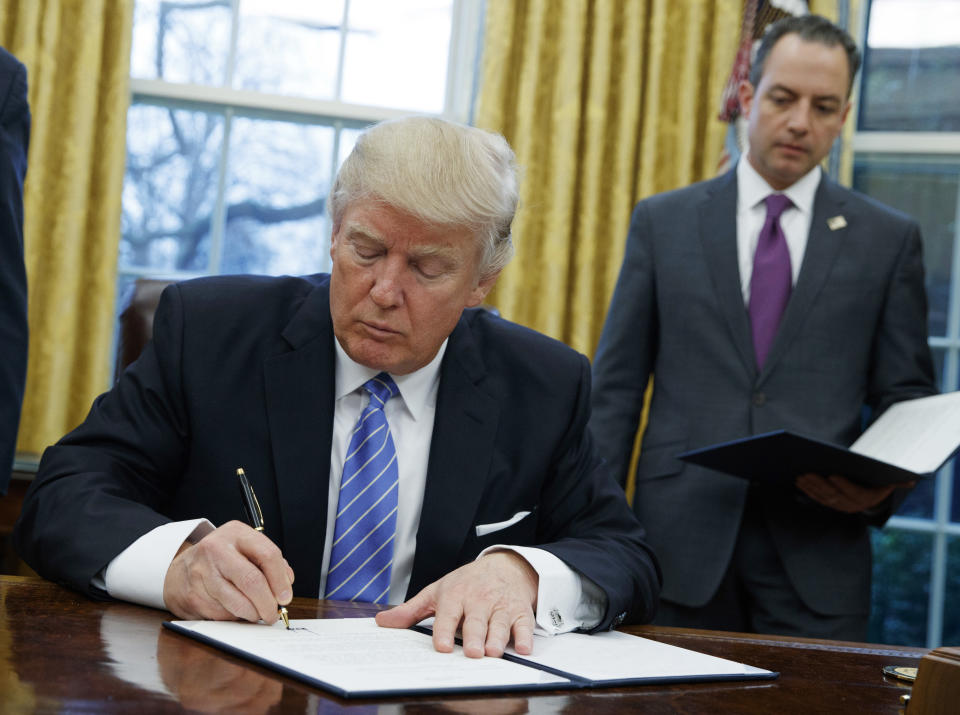 FILE - In this Jan. 23, 2017, file photo, U.S. President Donald Trump signs an executive order to withdraw the U.S. from the 12-nation Trans-Pacific Partnership (TPP) trade pact agreed to under the Obama administration in the Oval Office of the White House in Washington. Members of a Pacific Rim trade initiative rejected by Trump are to hold working-level talks Wednesday, July 12, 2017 in the Japanese mountain resort town of Hakone, west of Tokyo. The three-day meeting among envoys from the 11 remaining members of the TPP follows a breakthrough last week on a Japan-European Union trade deal seen as a repudiation of the U.S. moves to pull back from such arrangements. (AP Photo/Evan Vucci, File)