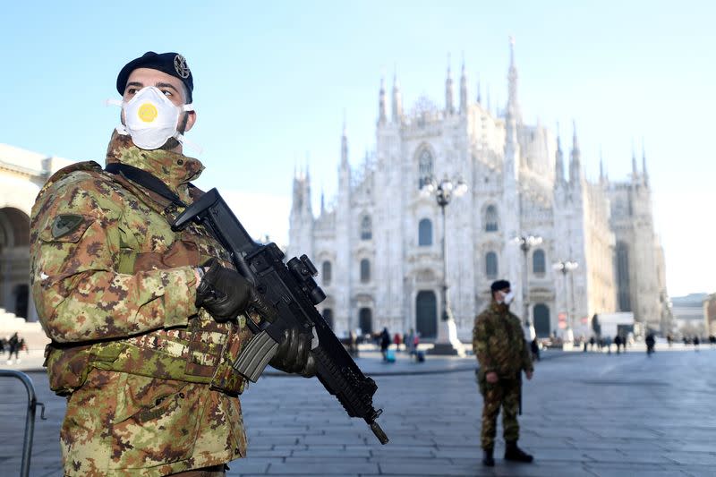 Military officers stand outside Duomo cathedral in Milan