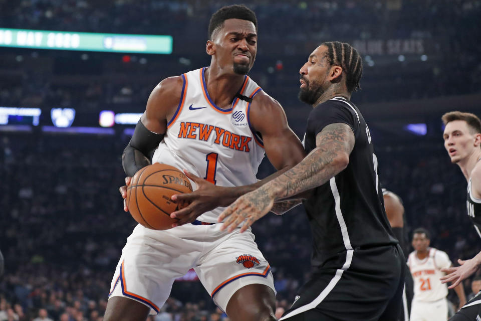 Brooklyn Nets forward Wilson Chandler (21) defends New York Knicks forward Bobby Portis (1) as Portis rives to the basket during the first half of an NBA basketball game in New York, Sunday, Jan. 26, 2020. (AP Photo/Kathy Willens)