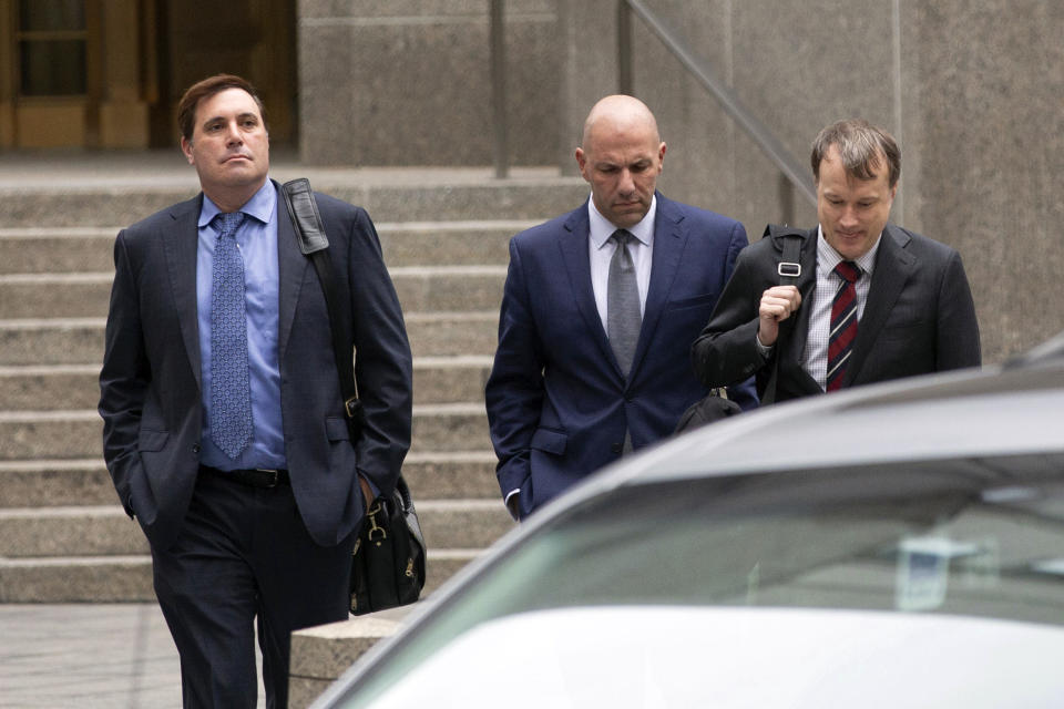 David Correia, center, arrives with his lawyers at federal court, Thursday, Oct. 17, 2019, in New York. Correia and Andrey Kukushkin were set to be arraigned Thursday on charges they conspired with associates of Rudy Giuliani to make illegal campaign contributions. (AP Photo/Kevin Hagen).