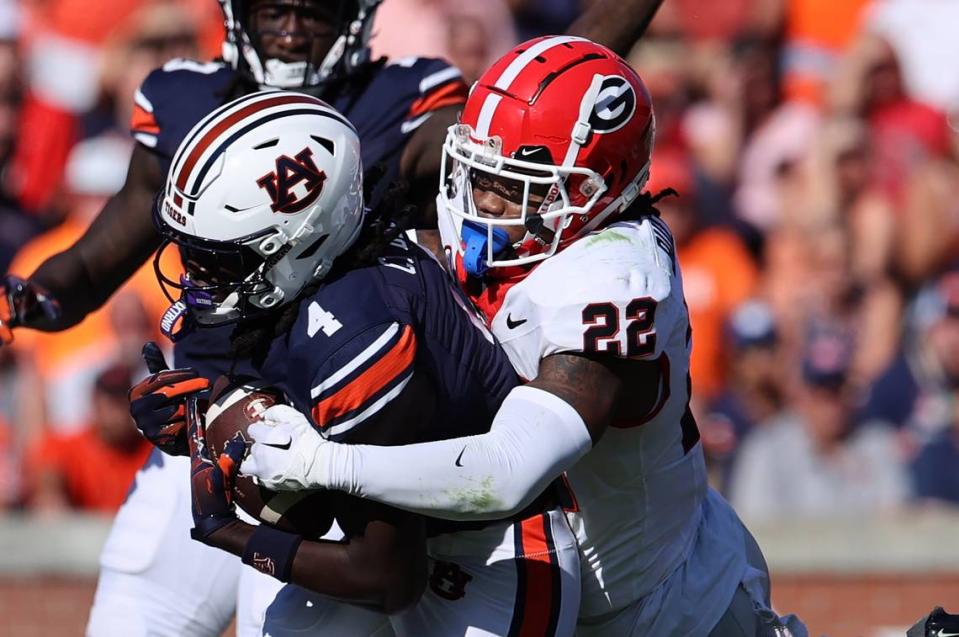 Sep 30, 2023; Auburn, Alabama, USA; Georgia Bulldogs defensive back Javon Bullard (22) tackles Auburn Tigers wide receiver Camden Brown (4) during the second quarter at Jordan-Hare Stadium. Mandatory Credit: John Reed-USA TODAY Sports