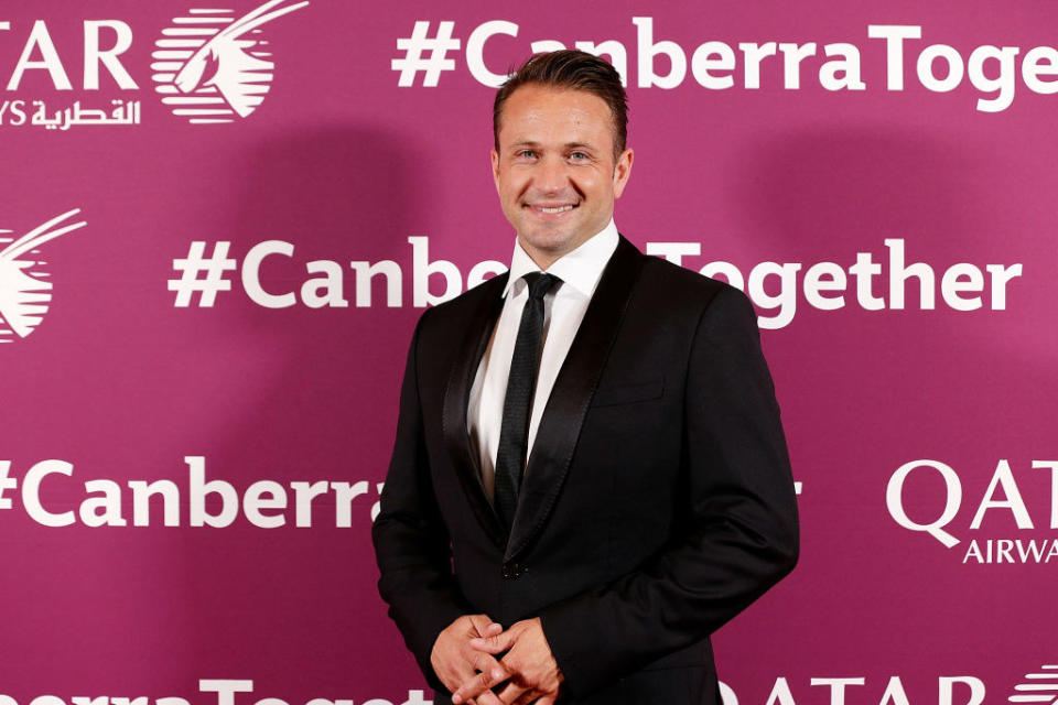 Doran smiling on the red carpet in a suit