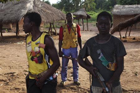 Militia fighters known as anti-balaka pose for a photograph as they stand guard in Mbakate village, Central African Republic November 25, 2013. REUTERS/Joe Penney