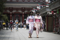 Two women in traditional kimonos wear face masks to help curb the spread of the coronavirus as they visit the Sensoji temple in Tokyo on Friday, Aug. 7, 2020. (AP Photo/Hiro Komae)