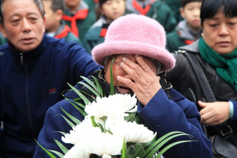 A survivor cries during a memorial ceremony at the Memorial Hall of the Victims in Nanjing Massacre by Japanese Invaders ahead of China's National Memorial Day for Nanjing massacre victims in Nanjing city, east China's Jiangsu province on December 4, 2017