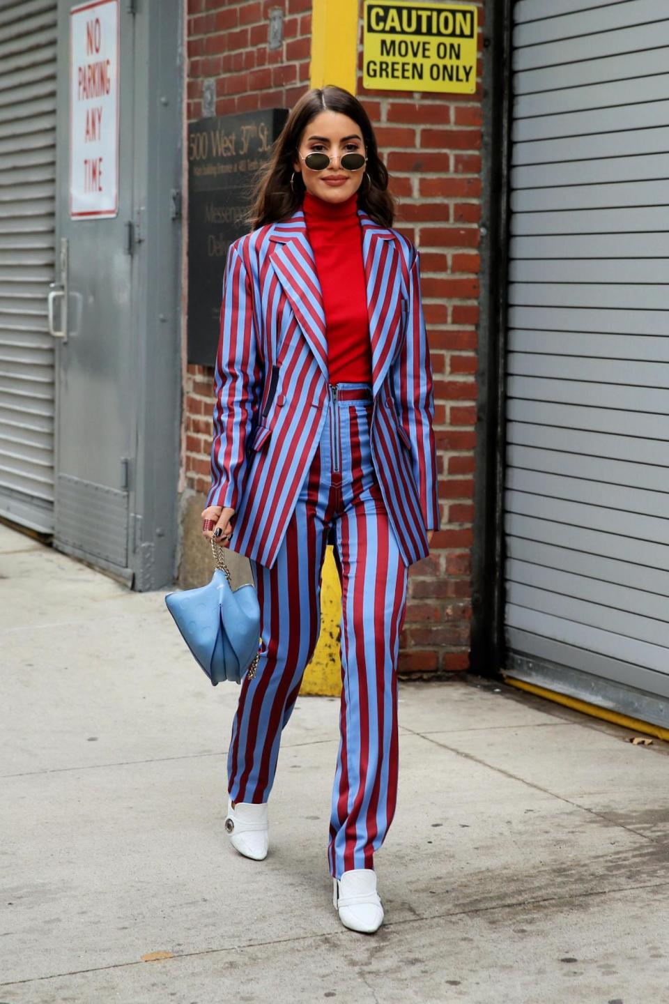 Fashion blogger Camila Coelho, wearing a silk striped pants suit, attends Self-Portrait AW18 show, NYC February 2018 (Christopher Peterson/Splash News)