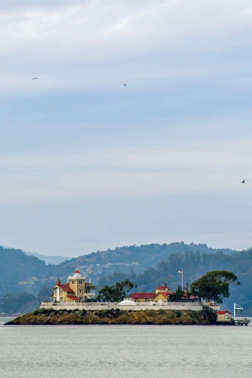 East Brother Island in San Pablo Straight, with hilly landscape in the distance.