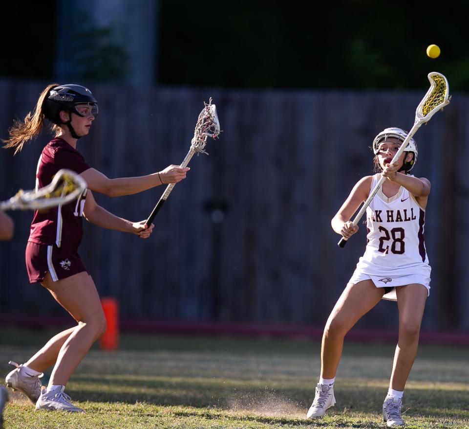 Oak Hall Eagles attack Isla Montes (28) passes the ball in the first half. Oak Hall girls lacrosse hosted St. Augustine in class 1A playoffs at Oak Hall High School in Gainesville, FL on Thursday, April 20, 2023. [Doug Engle/Gainesville Sun]