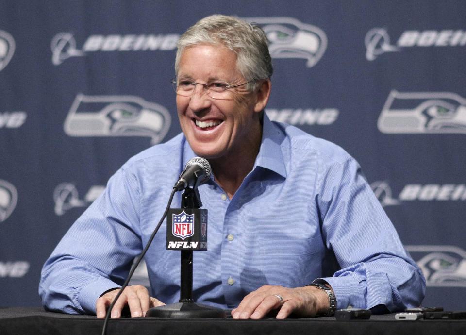 Seattle Seahawks NFL football head coach Pete Carroll talks to reporters during a news conference Friday, April 4, 2014, in Renton, Wash. The Seahawks have locked up coach Carroll with a three-year contract extension after he led the franchise to its first Super Bowl title. (AP Photo/Marcus R. Donner)