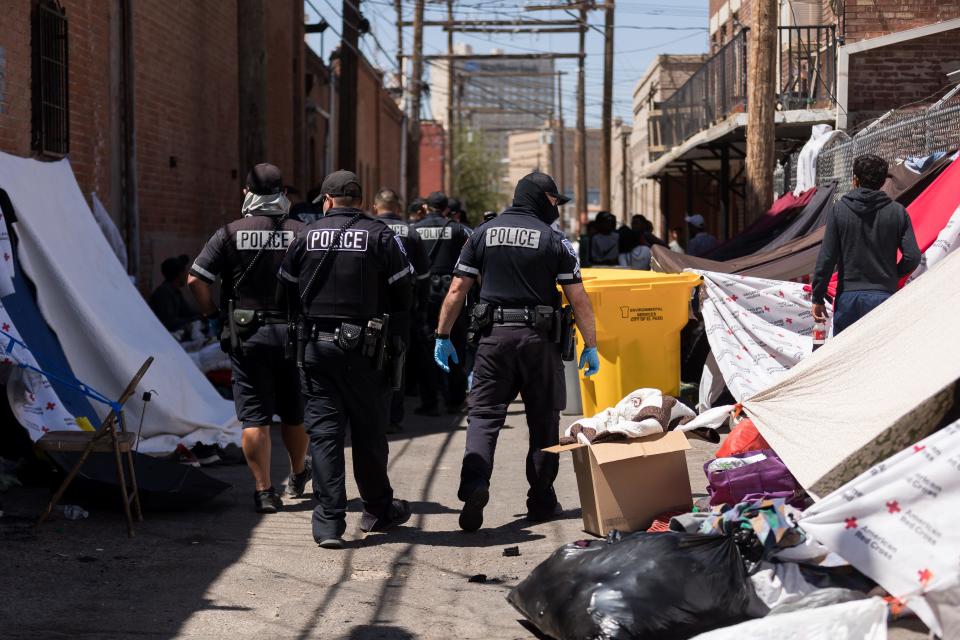 El Paso police patrol an alley where migrants are staying next to Sacred Heart Church in Downtown El Paso in 2023.