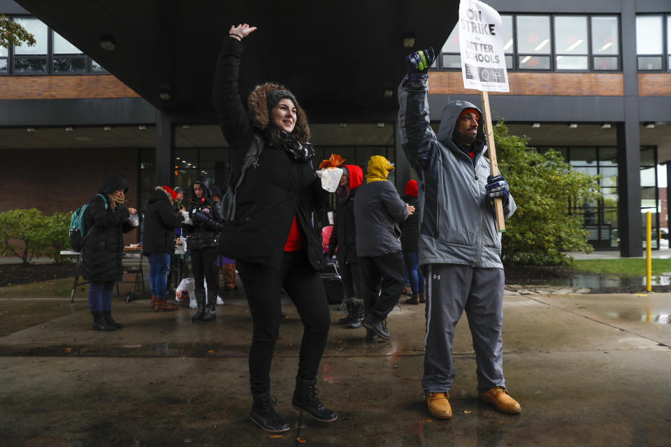 Chicago Teachers Union members, from left, Genevieve Roland (cq), a fifth year physics teacher and science department head, and Richie Foreman (cq), a second year counselor, stand on the picket line outside of Roberto Clemente Community Academy in Chicago on the tenth school day of the teachers strike, seen here on Wednesday, Oct. 30, 2019. CPS CTU (Jose M. Osorio/Chicago Tribune via AP)