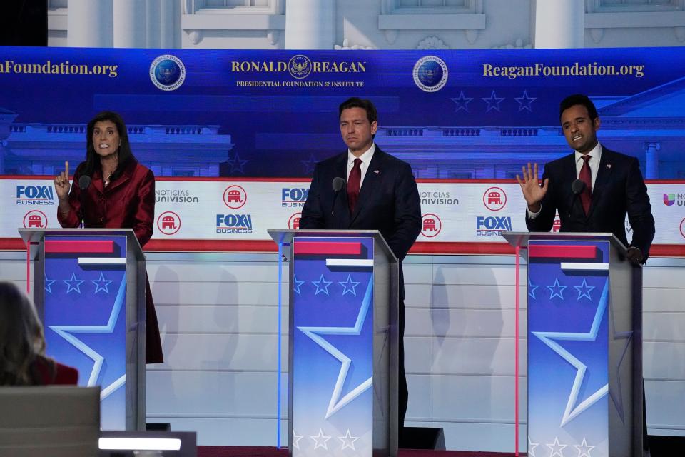 Former U.N. Ambassador Nikki Haley, left, argues a point with businessman Vivek Ramaswamy, right, between Florida Gov. Ron DeSantis, center, during a Republican presidential primary debate hosted by FOX Business Network and Univision, Wednesday, Sept. 27, 2023, at the Ronald Reagan Presidential Library in Simi Valley, Calif.
