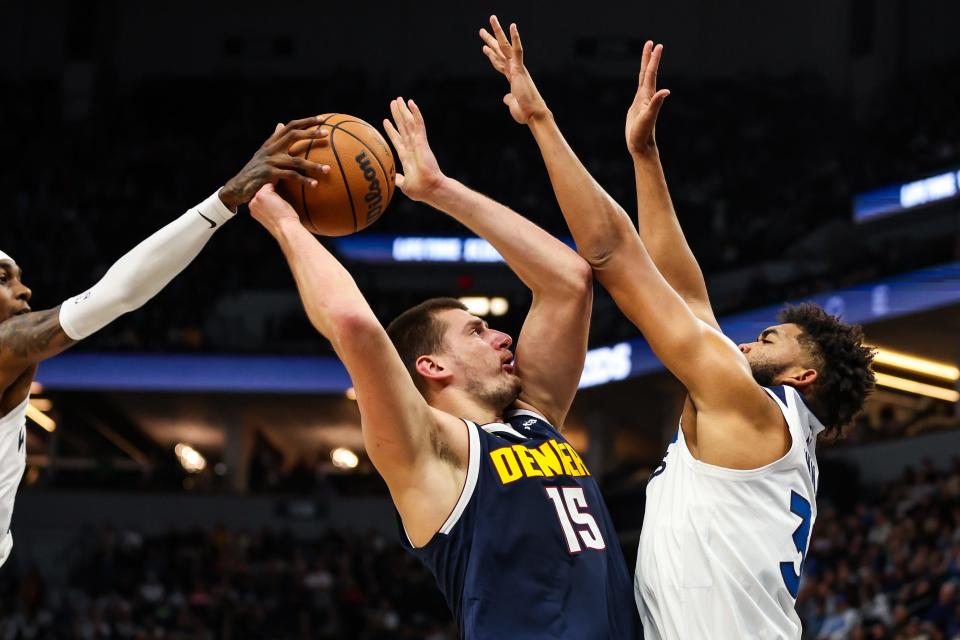 Minnesota Timberwolves forward Jaden McDaniels (3) blocks a shot by Denver Nuggets center Nikola Jokic (15) during the first half at Target Center.