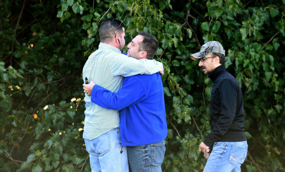 <p>Unidentified bystanders embrace as police and Emergency Medical Services respond to a shooting at a business park in the Edgewood area of Harford County, Md., Wednesday, Oct. 8, 2017. (Photo: Matt Button/The Baltimore Sun via AP) </p>