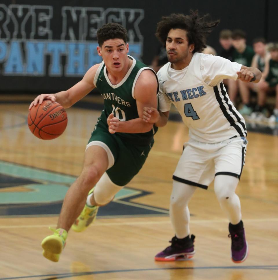 Pleasantville's Daniel Picart drives past Rye Neck's Ethan Lithgow during their game at Rye Neck Feb. 10, 2023. Pleasantville won 54-47.