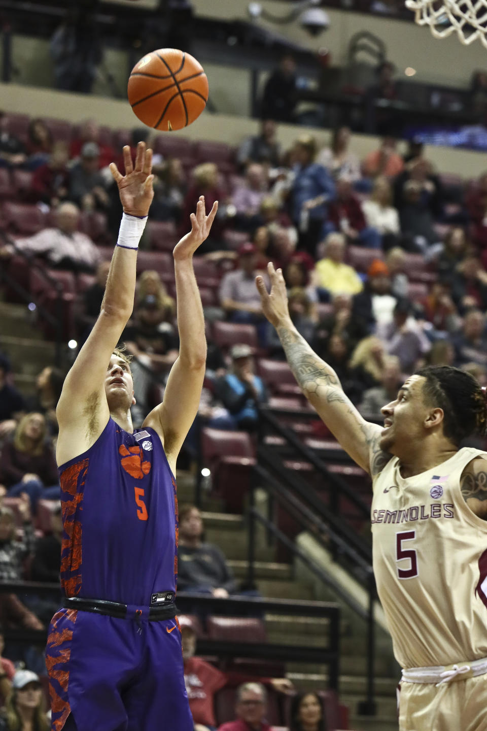 Clemson forward Hunter Tyson (5) shoots as Florida State forward De'Ante Green (5) defends in the first half of an NCAA college basketball game in Tallahassee, Fla., Saturday, Jan. 28, 2023. (AP Photo/Phil Sears)