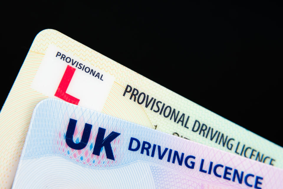 UK Driving Licence. Provisional and Full licence cards isolated on dark background. Macro. Selective focus. Stafford, United Kingdom, January 30, 2022.