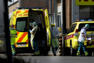 Medical personnel in protective gear prepare to receive a patient at a hospital in Antwerp, Belgium, Monday, April 13, 2020. The new coronavirus causes mild or moderate symptoms for most people, but for some, especially older adults and people with existing health problems, it can cause more severe illness or death. (AP Photo/Virginia Mayo)