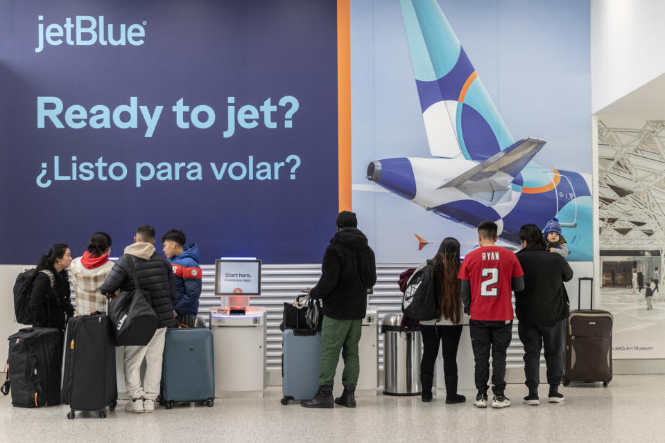 NEW YORK, NEW YORK - DECEMBER 23: Travelers check-in for their flights for JetBlue flights at John F. Kennedy International Airport (JFK) on December 23, 2023 in New York, New York. (Photo by Jeenah Moon/Getty Images)