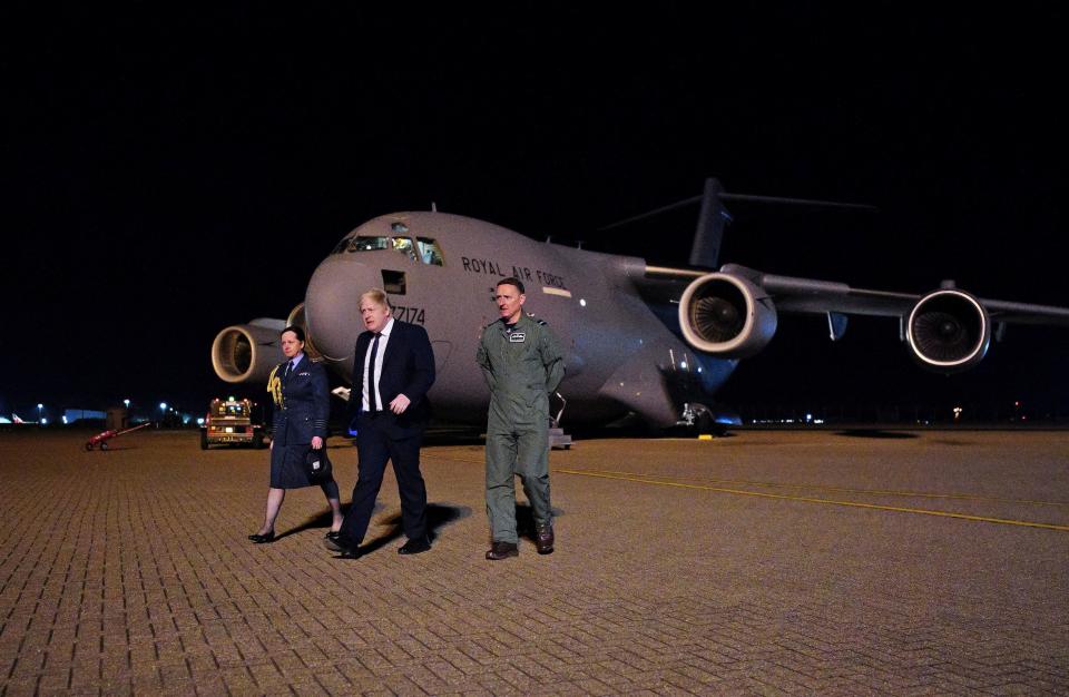 British Prime Minister Boris Johnson walks during a visit at Royal Air Force (RAF) Brize Norton station to meet military personnel and thank them for their work facilitating military support to Ukraine and NATO, at RAF Brize Norton, Britain, February 26, 2022. Ben Birchall/Pool via REUTERS