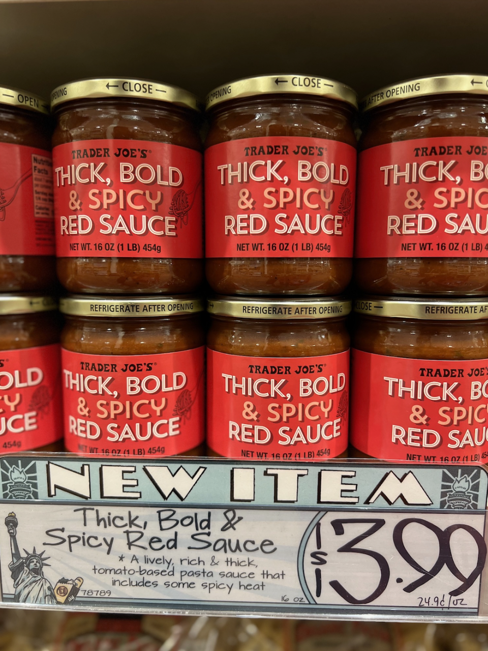 Trader Joe's Thick, Bold, & Spicy Red Sauce jars are displayed with a price tag of $3.99 each and a description highlighting the sauce's spicy heat