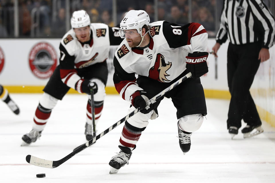 FILE - In this Feb. 8, 2020, file photo, Arizona Coyotes' Phil Kessel (81) moves the puck during the second period of an NHL hockey game against the Boston Bruins, in Boston. Injuries led to a disappointing first season in Arizona for Phil Kessel. Now that he's had time to heal up during the NHL's pause to the season, the high-scoring forward could help the Coyotes make a deep run once the season resumes. (AP Photo/Winslow Townson, File)