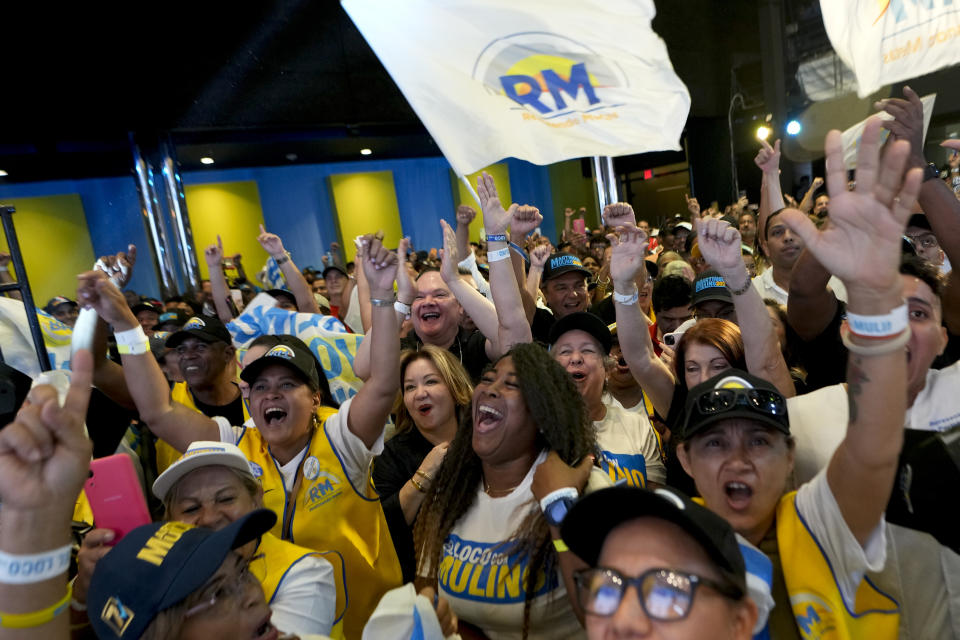 Supporters of Achieving Goals presidential candidate Jose Raul Mulino celebrate early results after the closing of polls for general elections in Panama City, Sunday, May 5, 2024. (AP Photo/Matias Delacroix)