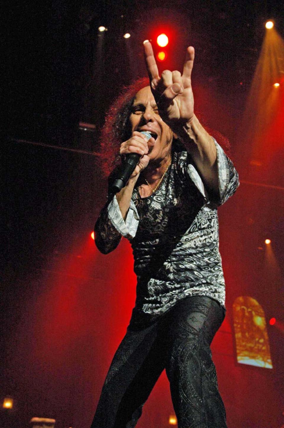 Ronie James Dio onstage throwing the horns