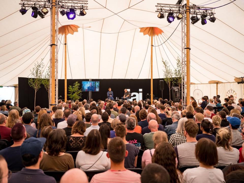 A crowd gathers under a tent at HowTheLightGetsIn Festival (Supplied)