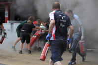 Racing team crews try to extinguish a fire in the Williams racing pit stand at the Circuit de Catalunya on May , 2012 in Montmelo on the outskirts of Barcelona after the Spanish Formula One Grand Prix. AFP PHOTO / JOSEP LAGOJOSEP LAGO/AFP/GettyImages