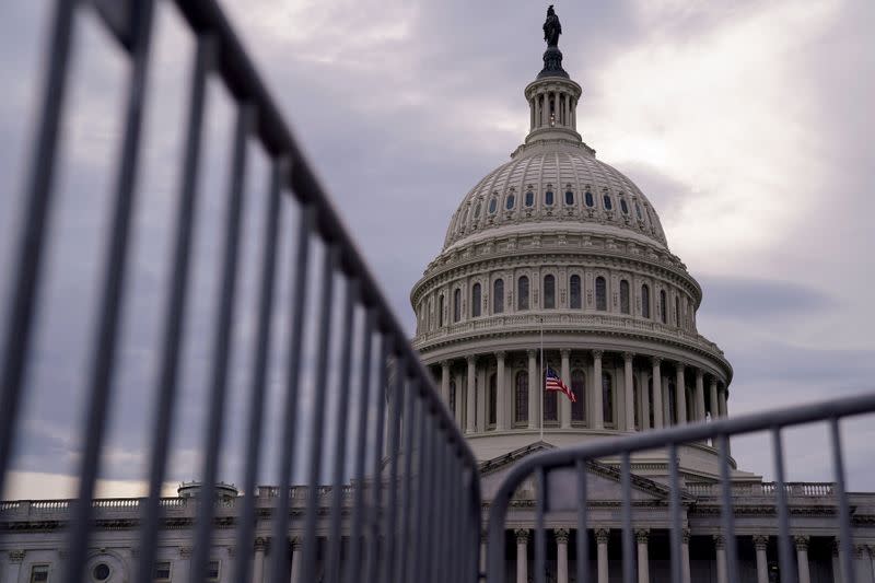 FILE PHOTO: The U.S. Capitol is seen behind a fence in Washington