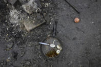 A pan lays on the floor in a makeshift camp in Calais, northern France, Saturday, Nov. 27, 2021. At the makeshift camps outside Calais, migrants are digging in, waiting for the chance to make a dash across the English Channel despite the news that at least 27 people died this week when their boat sank a few miles from the French coast. (AP Photo/Rafael Yaghobzadeh)