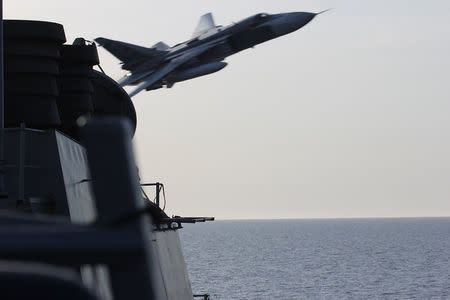 An U.S. Navy picture shows what appears to be a Russian Sukhoi SU-24 attack aircraft making a very low pass close to the U.S. guided missile destroyer USS Donald Cook in the Baltic Sea in this picture taken April 12, 2016 and released April 13, 2016. REUTERS/US Navy/Handout via Reuters