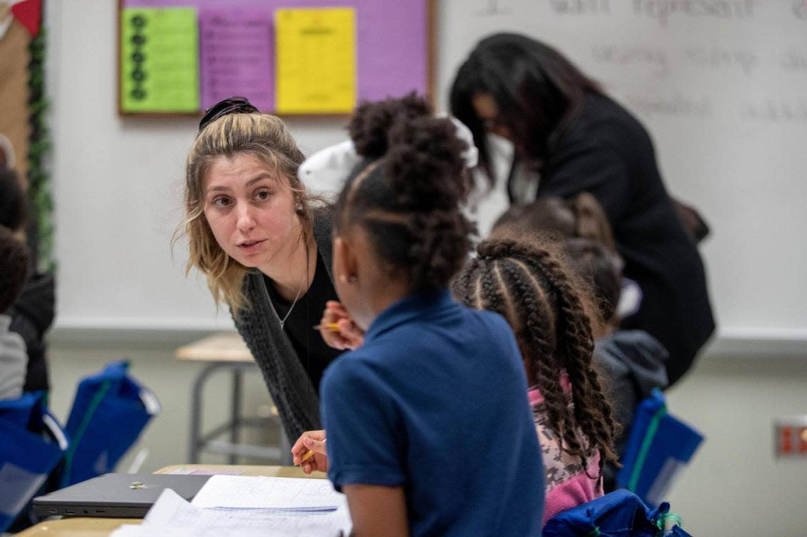 Teacher Alicia White helps students solve a math problem at David L. Walker Elementary in Crowley ISD on Feb. 7.