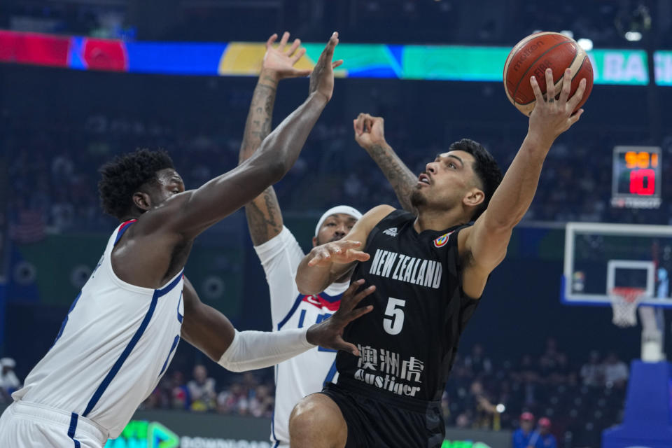 New Zealand guard Shea Ili (5) shoots over U.S. forward Jaren Jackson Jr. (13) during the first half of a Basketball World Cup group C match in Manila, Saturday, Aug. 26, 2023. (AP Photo/Michael Conroy)