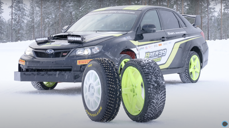 Subaru rally car with two different tires in front of it