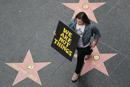 A demonstrator takes part in a #MeToo protest march for survivors of sexual assault and their supporters on the Hollywood Walk of Fame in Hollywood, Los Angeles, California U.S. November 12, 2017. REUTERS/Lucy Nicholson/Files