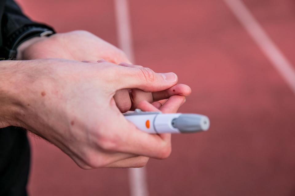 pricked finger ready for blood test