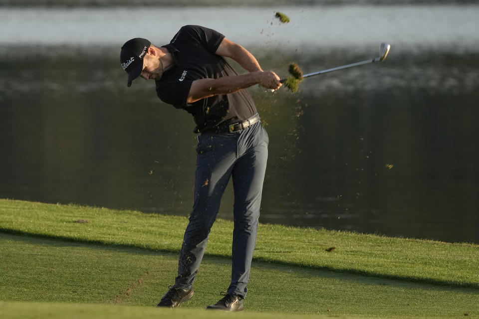 Wyndham Clark takes a divot as he hits from the 18th fairway during the first round of The Players Championship golf tournament Thursday, March 14, 2024, in Ponte Vedra Beach, Fla. (AP Photo/Lynne Sladky)