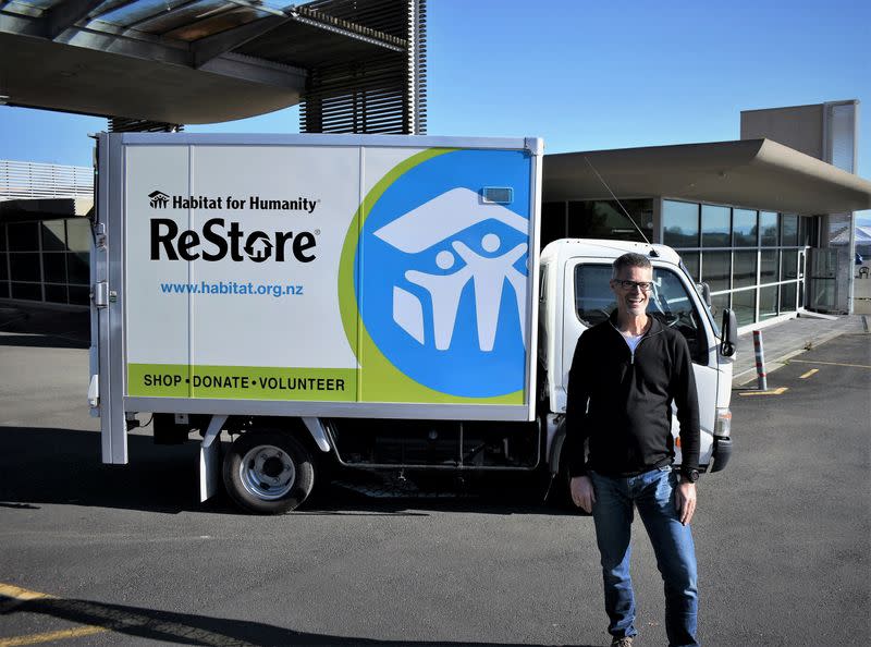 Nick Clarke, the general manager for Habitat for Humanity poses in front of a truck in Nelson