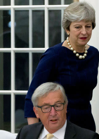 Britain's Prime Minister Theresa May walks past European Commission President Jean-Claude Juncker during a dinner in Tallinn ahead of an informal European Union leaders summit, Estonia September 28, 2017. REUTERS/Virginia Mayo/Pool