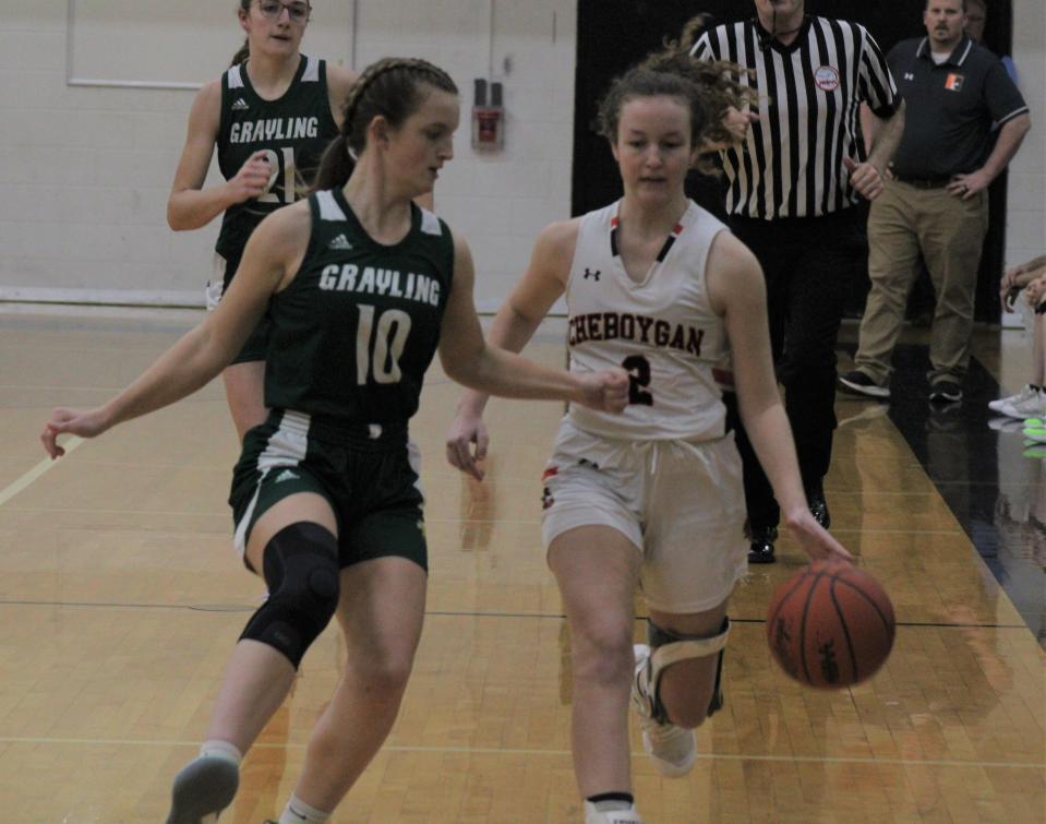 Cheboygan senior Emily Clark (right) keeps control of the ball while Grayling's Jillian Hartman (10) defends during the first half of Tuesday's game in Cheboygan.