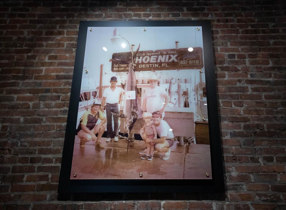 Vintage family photos are displayed at Slick Lips Seafood & Oyster House restaurant on Palafox Place in downtown Pensacola on Thursday, Aug. 10, 2023.