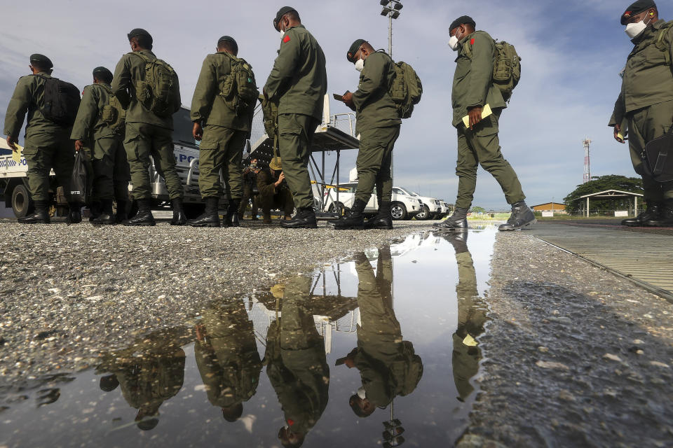 Fiji soldiers disembark from an Australian Air Force C130 in Honiara, Solomon Islands, Tuesday, Nov. 30, 2021. New Zealand announced Wednesday, Dec. 1, 2021, that they will send up to 65 military and police personnel to the Solomon Islands over the coming days after rioting and looting broke out there last week.(Gary Ramage via AP)