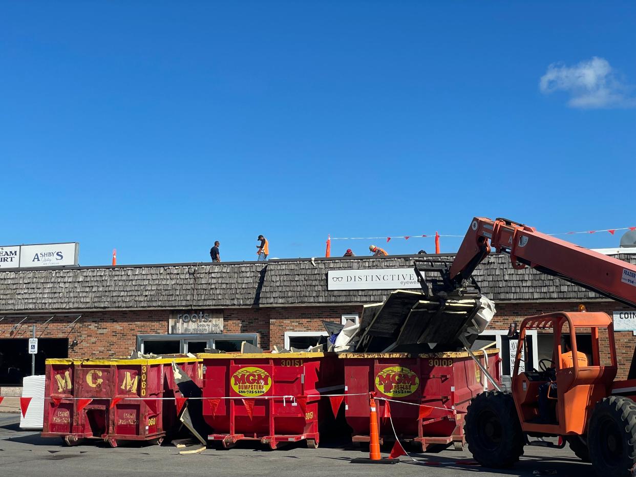 Construction workers repairing the roof of the St. Clair Riverview Plaza on Sept. 14, 2023.