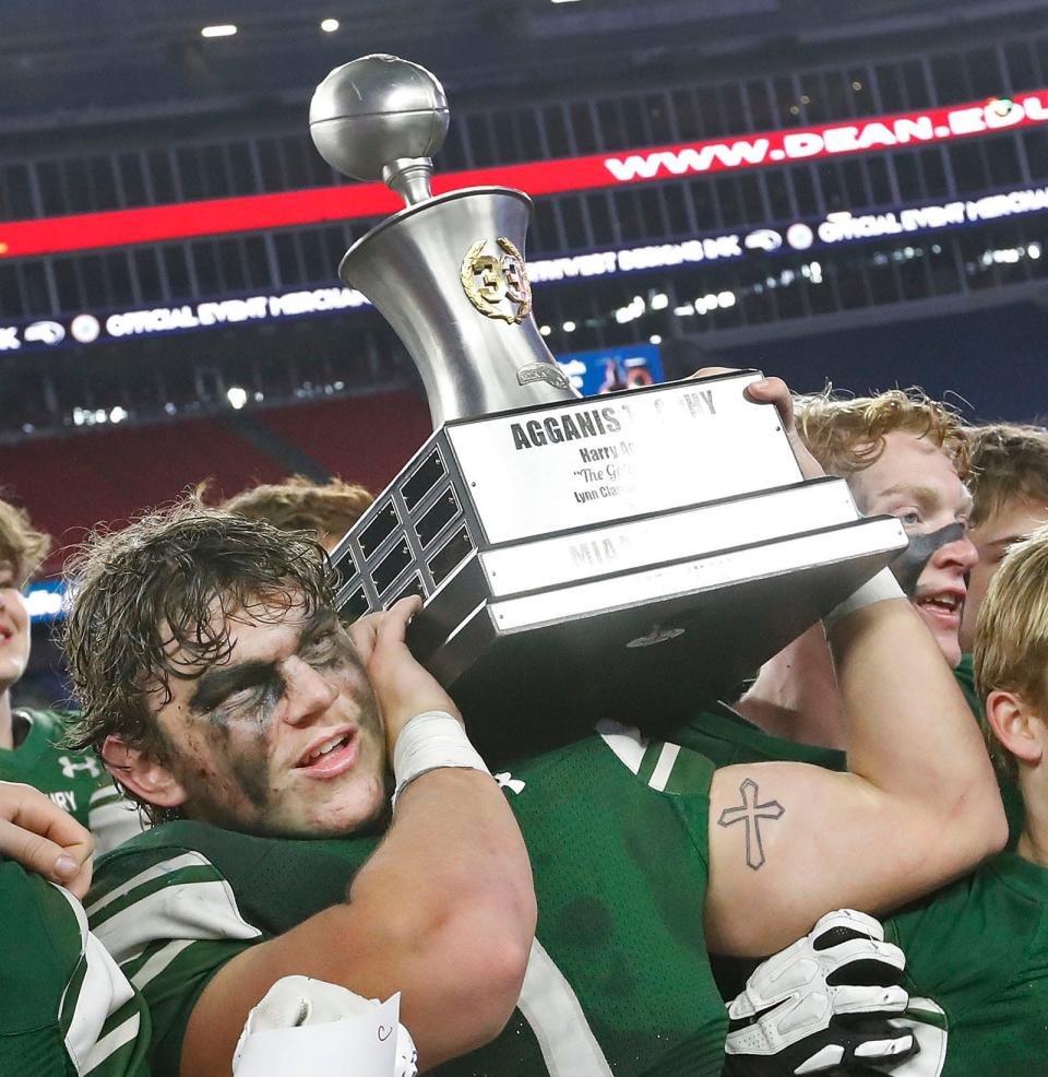 Duxbury football wins the MIAA Div. 4 state championship behind the running game of Alex Barlow, who scored five touchdowns. Here he's carrying the Agganis Trophy. Duxbury High and Scituate High play the MIAA Division 4 State Championship at Gillette Stadium on Friday, Dec. 1, 2023.