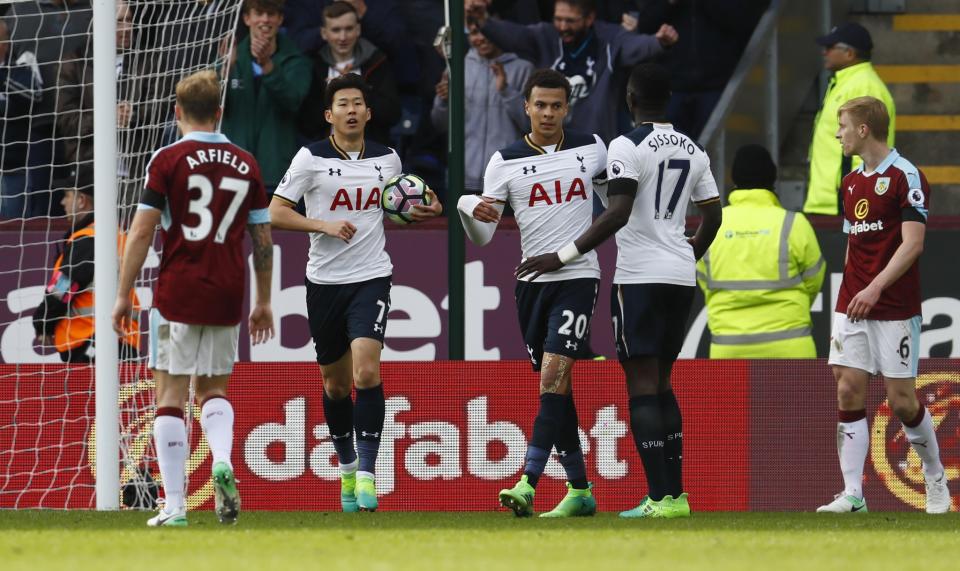 Tottenham’s Son Heung-min celebrates scoring their second goal with team mates as Burnley’s Ben Mee (R) looks dejected